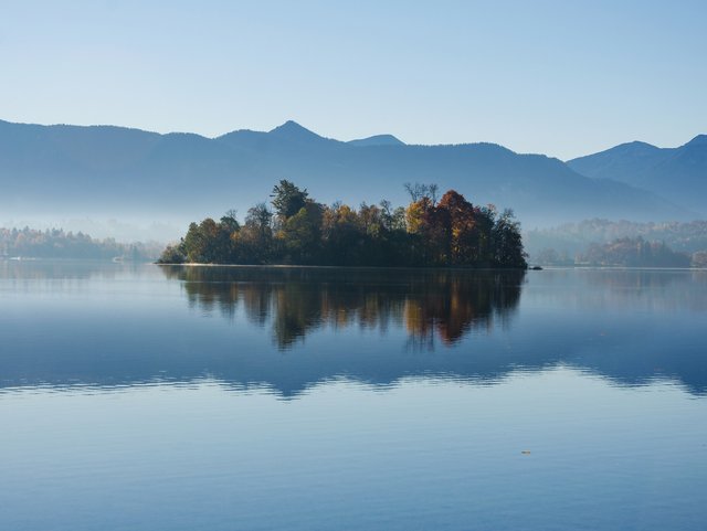 Blick auf eine Insel im Staffelsee mit den Bayerischen Alpen im Hintergrund