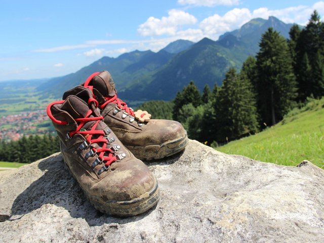 Wanderschuhe auf Felsen vor Bergpanorama